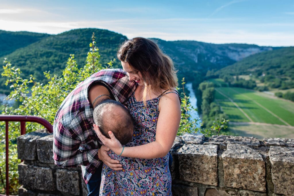 A kiss on baby bump in front of Aveyron river