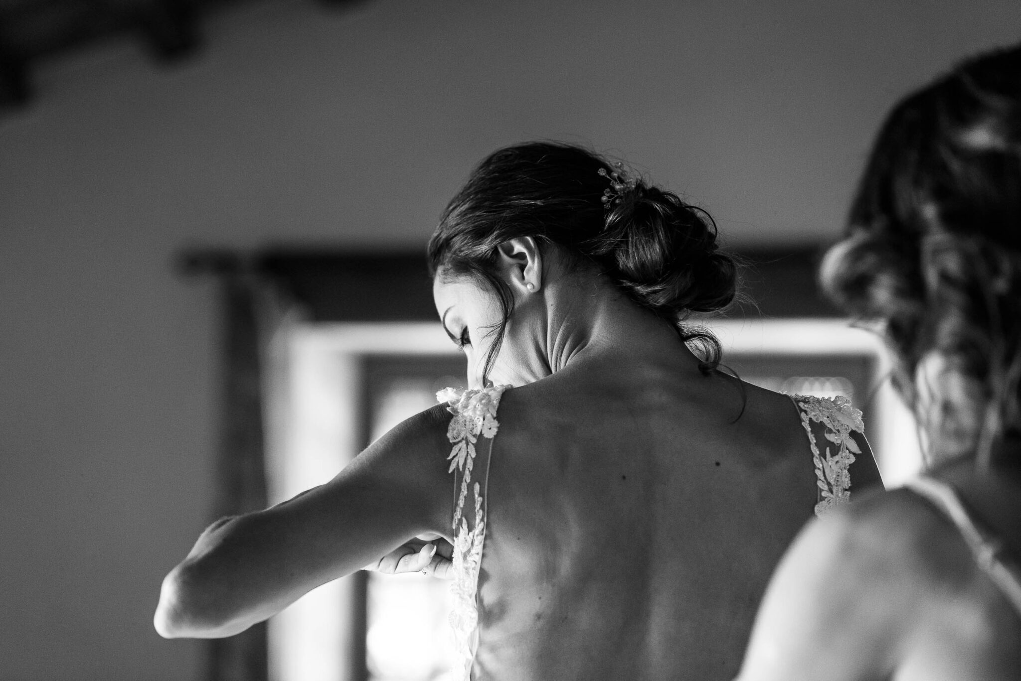 The Bride putting on the dress