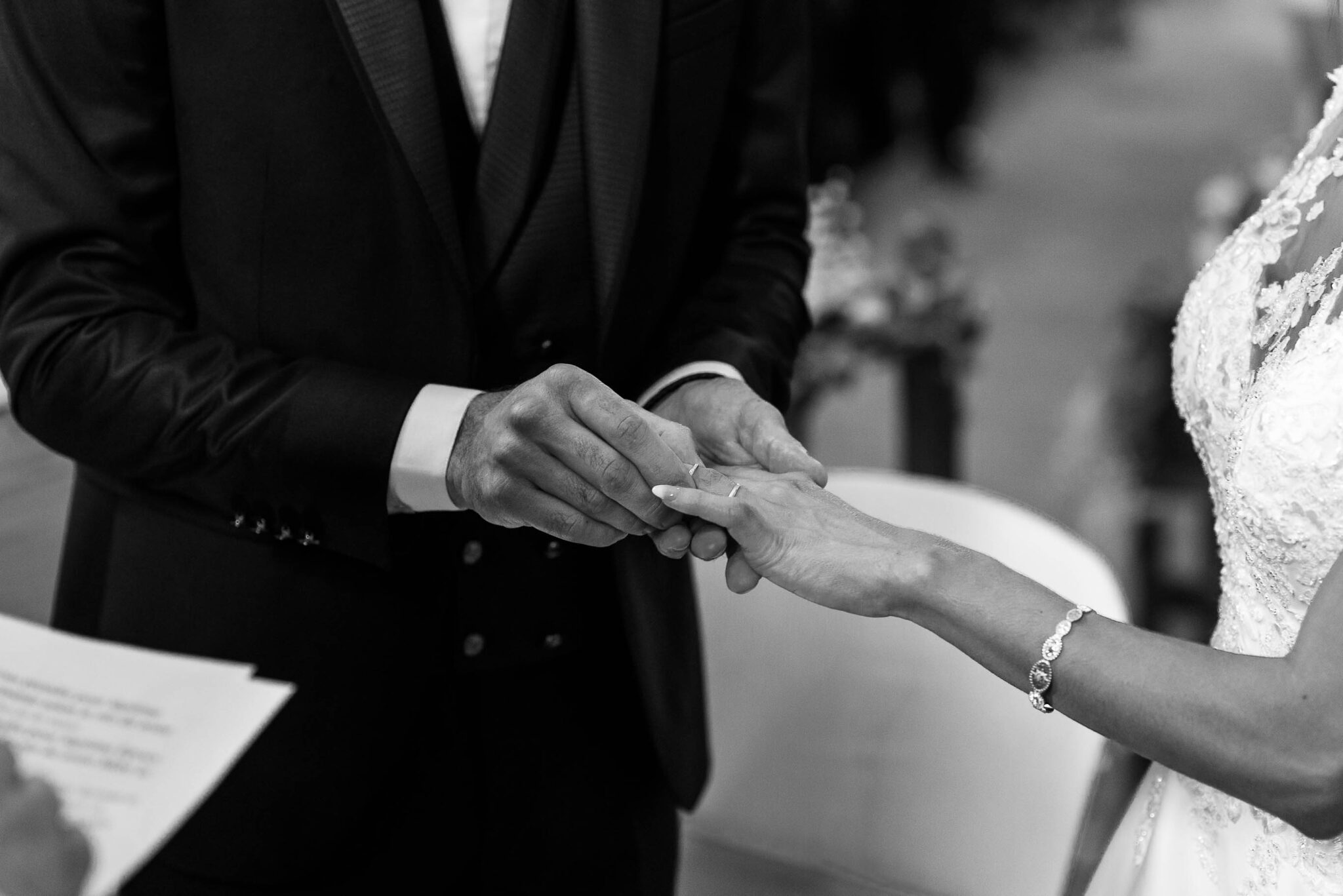 The bride and groom exchanging the wedding ring