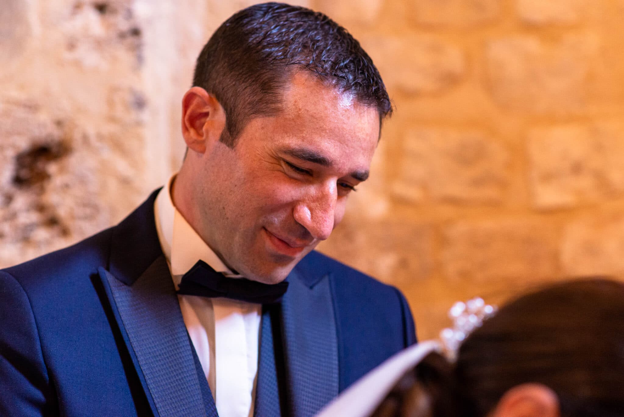 Groom watching the bride signing