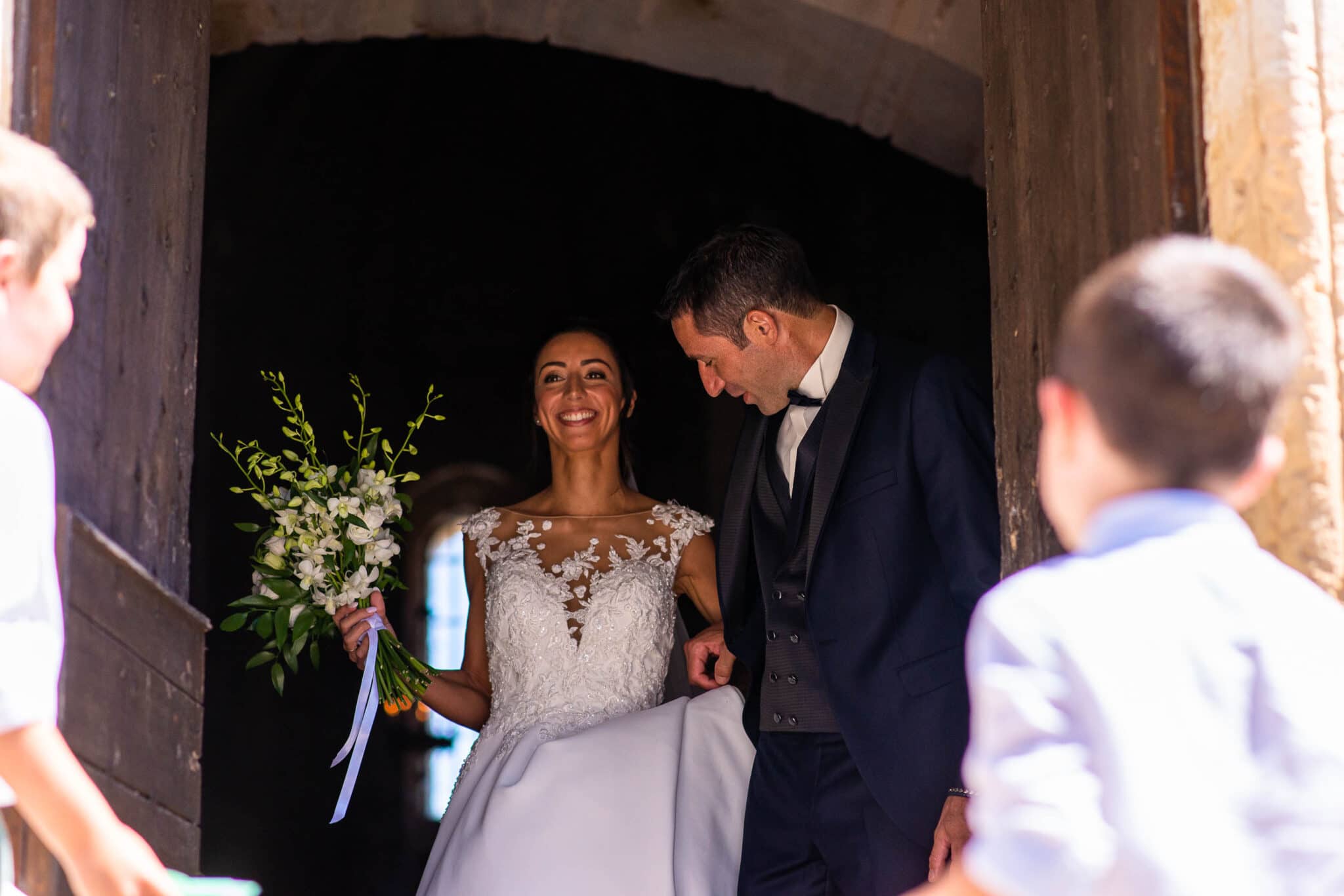 The groom and bride getting out of the church