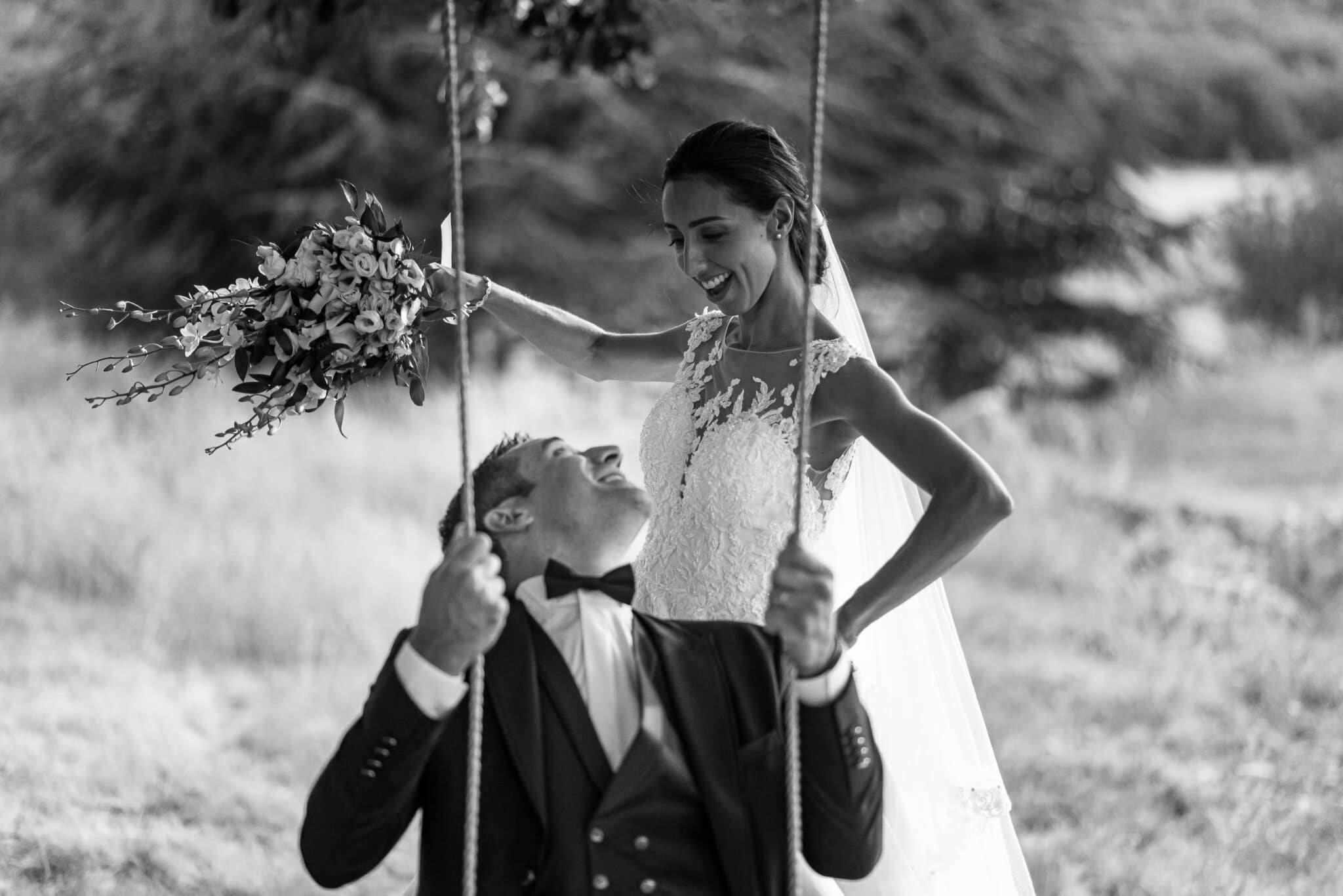 The newlyweds play on the swing